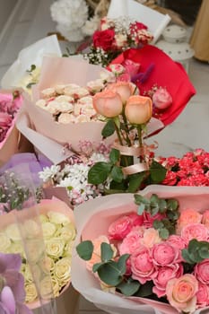 Ready bouquets of roses in gift paper, top view of the queen of flowers.