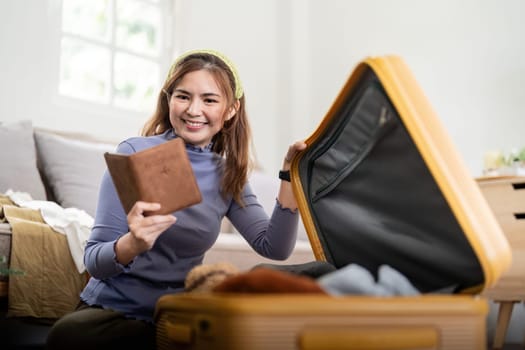 Woman packing suitcase for a new journey packing list for travel planning. prepare vacation. traveling.