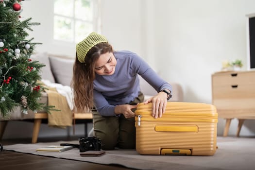 Beauty asian traveler woman packing prepare stuff and outfit clothes in suitcase travel bag luggage for holidays at home, weekend, tourist, journey.