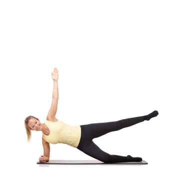 Woman, yoga and mat in studio for side plank, fitness or workout for healthy body, happy or core muscle. Person, portrait and pilates on floor for abdomen health on mockup space or white background.