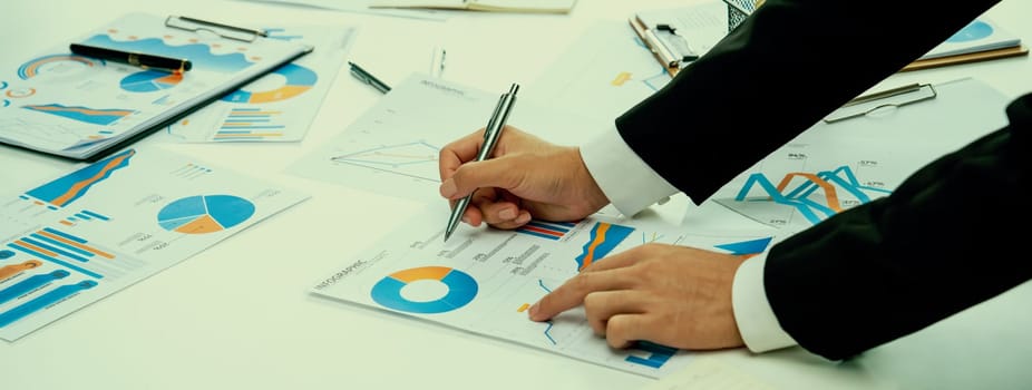 Business people in group meeting in formal attire share idea discussing report for company profit in creative workspace for start up business shot in close up view on group meeting table . Oratory .