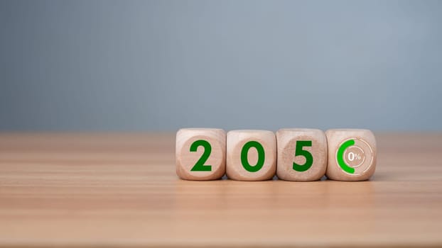 Wooden cubes with net zero icon in 2050 on wooden background, Net zero by 2050, Carbon neutral, Net zero green house gas emissions target, Climate neutral long term strategy, No toxic gases. 