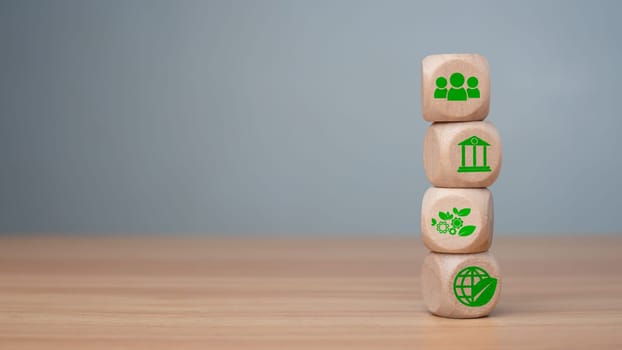 ESG concept of environmental, social and governance, wood block and icon on wooden background It is an idea for sustainable organizational development ​account the green environment.