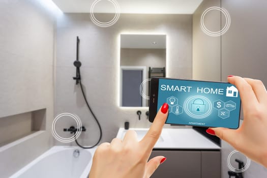 All the house in a phone. Close up of young woman user hands controlling electronic objects in modern luxury studio apartment via smart home interface on cell screen. Internet of things ios technology.