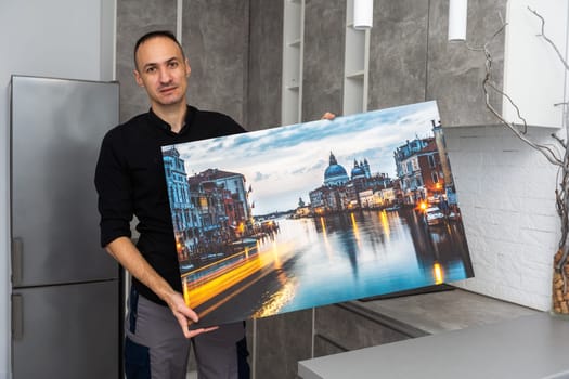 Photo canvas print. A man holding a photography with gallery wrap. High quality photo