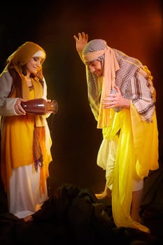 A couple in love or a married couple in stylized Eastern clothing from Israel, Palestine, Iran, Pakistan together. Tender photo session in the style of the Middle East and the Bible