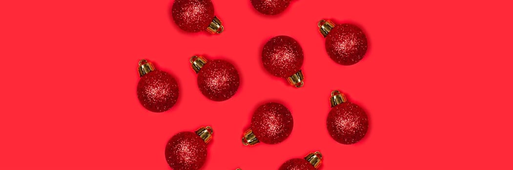 Banner with red Christmas balls on a bright background. The central composition, the decorations lie in the form of a circle.