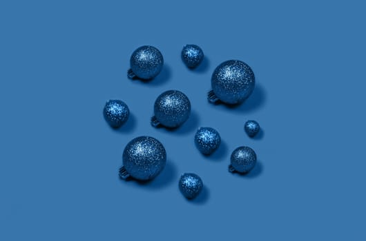 Volume Christmas composition of blue Christmas balls laid out in the form of circle on bright background.
