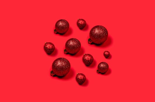 Red Christmas balls laid out in the form of circle on bright background.