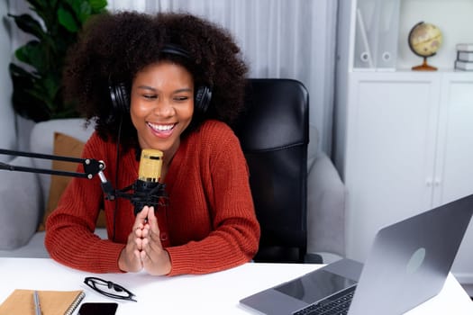 Host channel of beautiful African woman influencer talking with new listeners in broadcast studio. Time slot of life coach consultant on live social media online. Concept of giving advice. Tastemaker.
