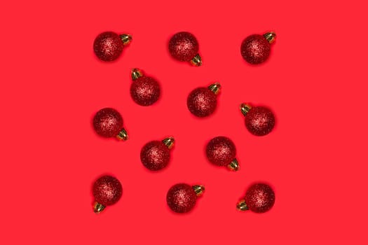 Red Christmas balls on a bright background. The central composition, the decorations lie in the form of a square.