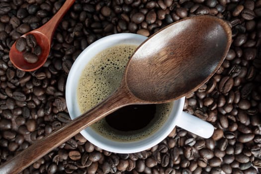 Coffee cup and beans on wooden table. Top view with copyspace. Flat lay.