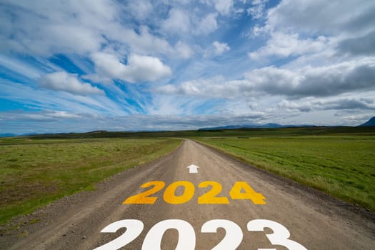 2024 New Year road trip travel and future vision concept . Nature landscape with highway road leading forward to happy new year celebration in the beginning of 2024 for bliss and successful start .