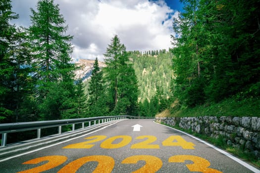 2024 New Year road trip travel and future vision concept . Nature landscape with highway road leading forward to happy new year celebration in the beginning of 2024 for bliss and successful start .