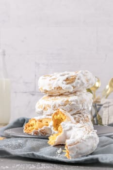 Sweet portuguese donuts with white glaze. Donuts baked at home. Simple and tasty dessert.