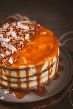 Delicious caramel cake with small pieces of pecan nuts and coconut shavings.