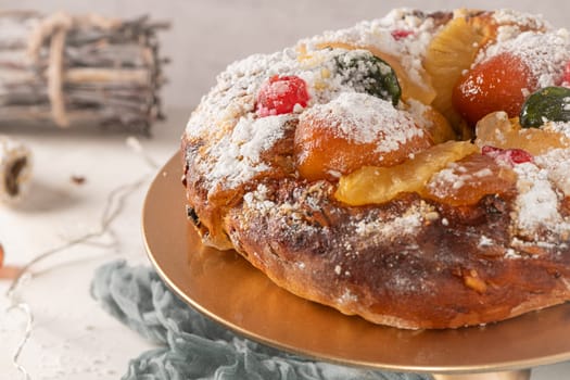 Bolo do Rei or King's Cake, Made for Christmas, Carnavale or Mardi Gras with Christmas season elements in Background.