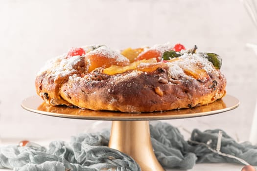 Bolo do Rei or King's Cake, Made for Christmas, Carnavale or Mardi Gras with Christmas season elements in Background.