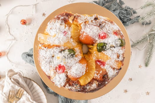 Bolo do Rei or King's Cake, Made for Christmas, Carnavale or Mardi Gras with Christmas season elements in Background.