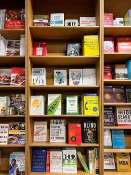 Shelves with books on personal development and management in a store. High quality photo