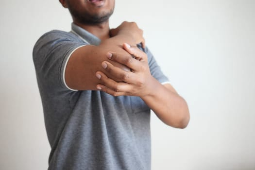 man with elbow pain. Pain relief concept
