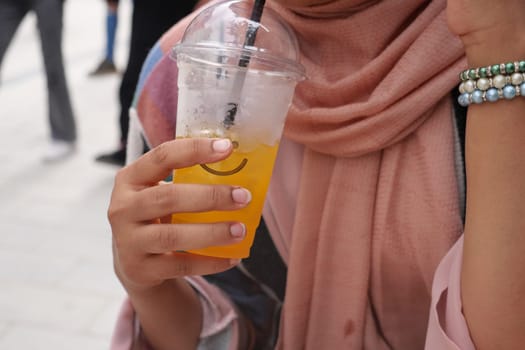 women drinking orange juice close up .