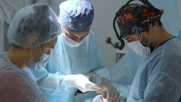 Close up of surgery performed by professional specialists. Action. Concentrated work of a surgeon