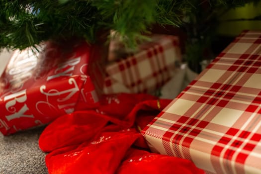 Christmas gifts laying underneath of fir tree branches