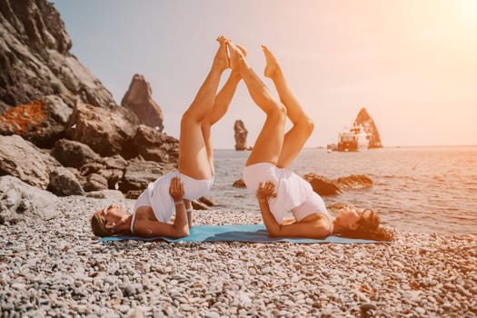 Woman sea yoga. Back view of free calm happy satisfied woman with long hair standing on top rock with yoga position against of sky by the sea. Healthy lifestyle outdoors in nature, fitness concept.