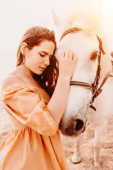 A white horse and a woman in a dress stand on a beach, with the sky and sea creating a picturesque backdrop for the scene