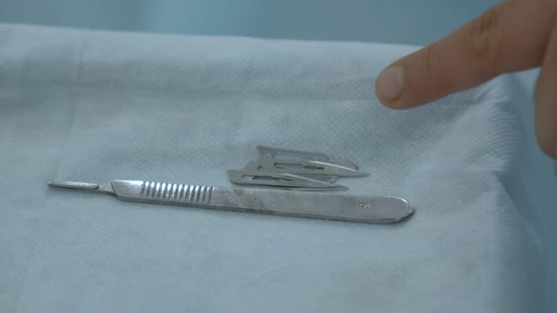 Close up shot of table with professional surgical instruments. Action. Modern sterile medical facility