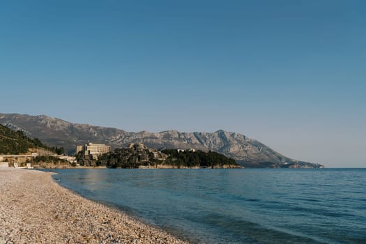 Deserted main beach of Budva overlooking the mountains by the sea. Montenegro. High quality photo