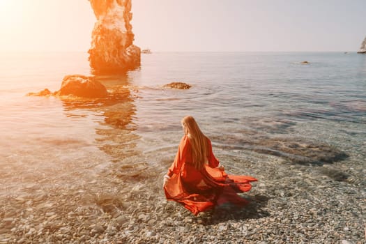 Woman travel sea. Happy tourist taking picture outdoors for memories. Woman traveler looks at the edge of the cliff on the sea bay of mountains, sharing travel adventure journey.