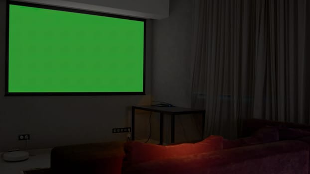 A room with a large green screen. Media. A large spacious room with a green projector. High quality 4k footage