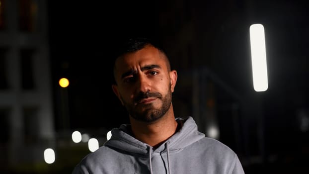 Night portrait with a gloomy man. Media. Late evening with a handsome well-groomed man who frowns. High quality 4k footage