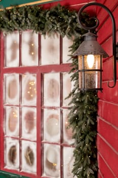 Old Christmas lantern in evening on wooden background.