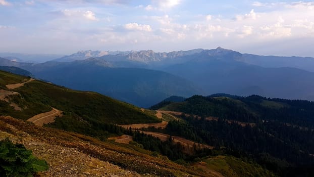 A view of a mountain range with a road winding through it, featured on unsplash, hurufiyya, panorama, hdr