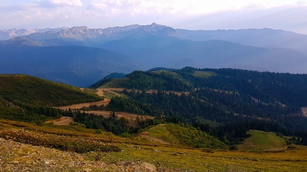 A view of a mountain range with a road winding through it, featured on unsplash, hurufiyya, panorama, hdr