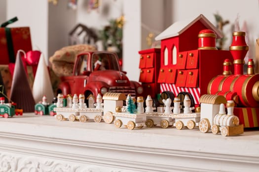 Wooden toy train. Christmas trip on a white isolated background. Christmas card. Copy space.