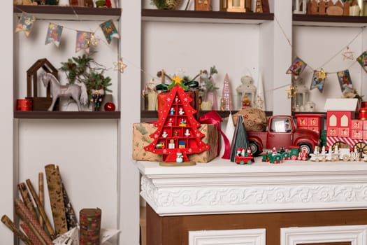 Wooden toy houses and christmas candlestick on store showcase decorating for New Year and Christmas