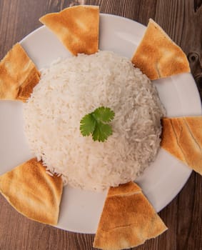 Lebanese recipe Mouloukhia , Melokhiyah, corete leaf and coriander rice chicken, grilled pita. High quality photo