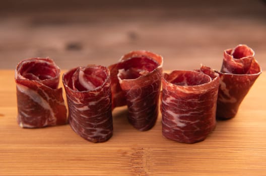 Dry-cured Spanish ham, Serrano ham, Bellota ham, Italian prosciutto crudo or Parma ham, wagyu slice. High quality photo