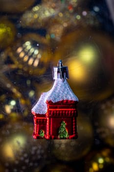 christmas tree toy christmas red house on a golden background.