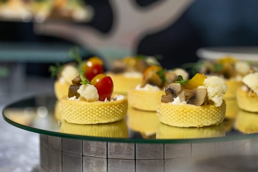 tartlet close-up on the buffet table. tartlet with mushroom sauce and broccoli.