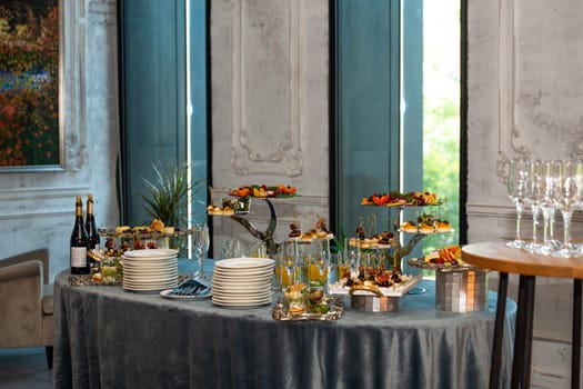 various snacks on stands on the buffet table. self-service at the event.