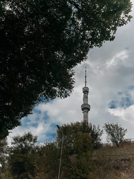 Almaty TV Tower view through the trees in summer.