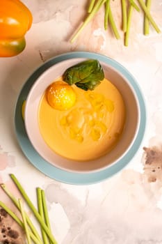 top view pumpkin cream soup with a slice of lemon in a plate on the table.