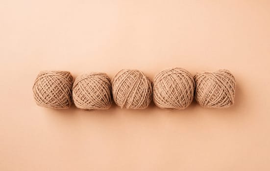 Color of the year 2024: Peach Fuzz. bright yarn wool in a raw on background, top view flat lay