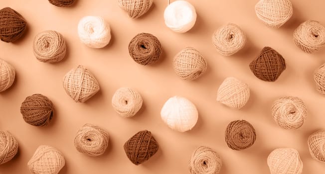 Color of the year 2024: Peach Fuzz. bright and colorful yarn wool pattern on background, top view flat lay