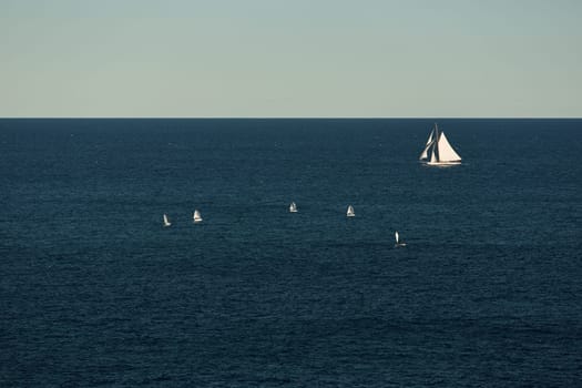 Monaco, lonely vintage sail yacht in sea at sunset, huge sail boat, wealth life of billionaires . High quality photo